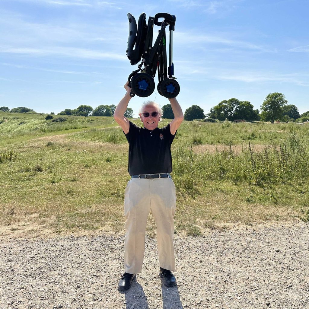 old man holding the foldable scooter